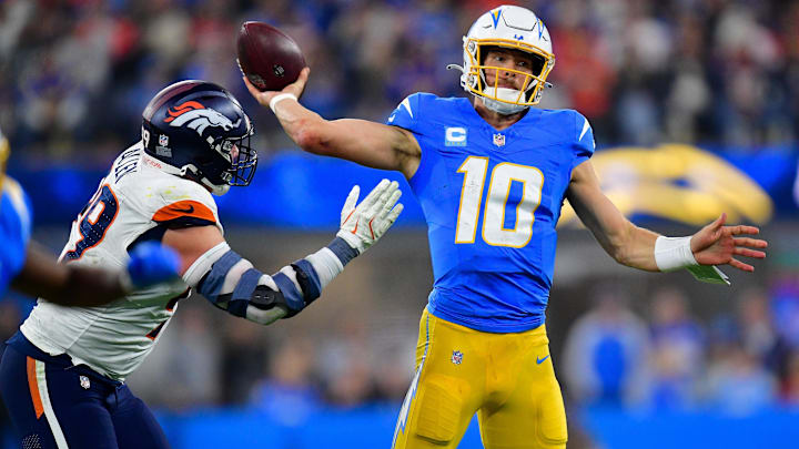 Dec 19, 2024; Inglewood, California, USA; Los Angeles Chargers quarterback Justin Herbert (10) throws as Denver Broncos defensive end Zach Allen (99) moves in during the second half at SoFi Stadium. 