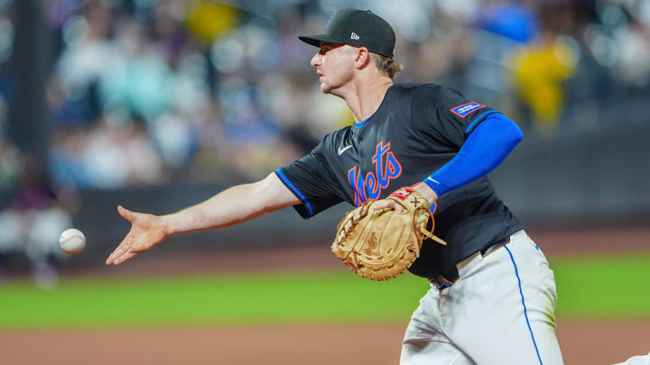 Jun 14, 2024; New York City, New York, USA; New York Mets first baseman Pete Alonso (20) flips the ball to pitcher Adam Ottavino (not pictured) covering first base after fielding a ground ball hit by San Diego Padres right fielder Frenando Tatis Jr. (not pictured)  during the sixth inning at Citi Field. 