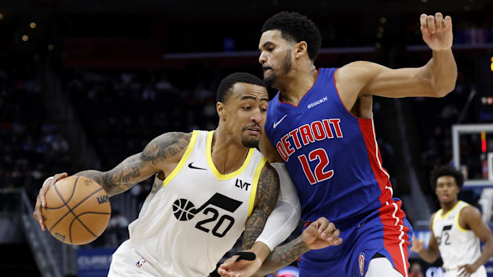 Dec 19, 2024; Detroit, Michigan, USA;  Utah Jazz forward John Collins (20) dribbles on Detroit Pistons forward Tobias Harris (12) in the fourth quarter at Little Caesars Arena. Mandatory Credit: Rick Osentoski-Imagn Images