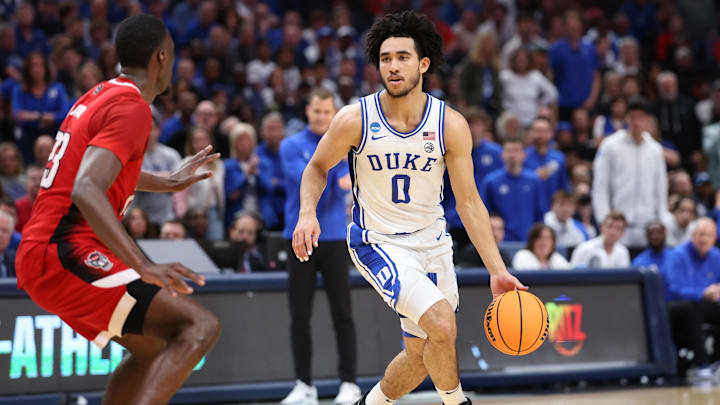 Mar 31, 2024; Dallas, TX, USA; Duke Blue Devils guard Jared McCain (0) controls the ball against North Carolina State Wolfpack forward Mohamed Diarra (23) in the first half in the finals of the South Regional of the 2024 NCAA Tournament at American Airline Center. Mar 31, 2024; Dallas, TX, USA; Duke Blue Devils guard Jared McCain (0) controls the ball against North Carolina State Wolfpack forward Mohamed Diarra (23) in the first half in the finals of the South Regional of the 2024 NCAA Tournament at American Airline Center.