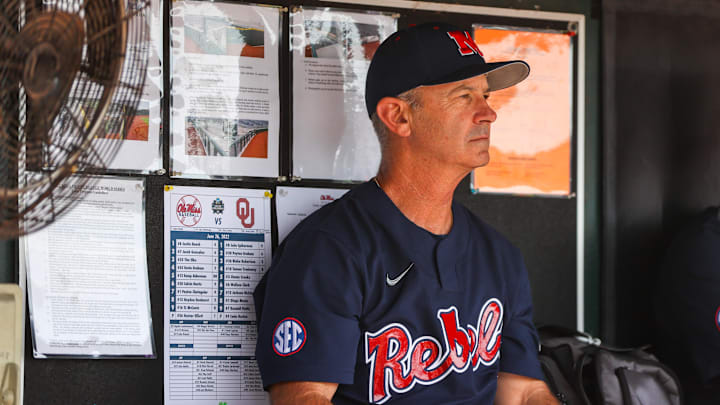 Jun 26, 2022; Omaha, NE, USA; Ole Miss Head Coach Mike Bianco sits in the dugout just before the first inning against the Oklahoma Sooners at Charles Schwab Field. Mandatory Credit: Jaylynn Nash-Imagn Images Jun 26, 2022; Omaha, NE, USA; Ole Miss Head Coach Mike Bianco sits in the dugout just before the first inning against the Oklahoma Sooners at Charles Schwab Field. Mandatory Credit: Jaylynn Nash-Imagn Images