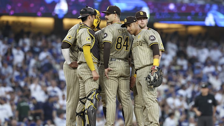 Oct 5, 2024; Los Angeles, California, USA; San Diego Padres pitcher Dylan Cease (84) huddles with the team in the second inning against the Los Angeles Dodgers during game one of the NLDS for the 2024 MLB Playoffs at Dodger Stadium. Mandatory Credit: Kiyoshi Mio-Imagn Images
