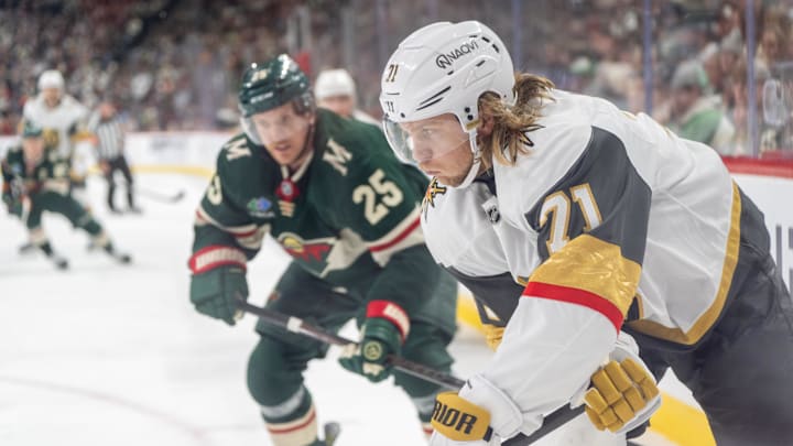 Apr 24, 2025; Saint Paul, Minnesota, USA; Vegas Golden Knights center Brett Howden (21) plays the puck in the corner as Minnesota Wild defenseman Jonas Brodin (25) defends on the play in the third period in game three of the first round of the 2025 Stanley Cup Playoffs at Xcel Energy Center. Mandatory Credit: Matt Blewett-Imagn Images