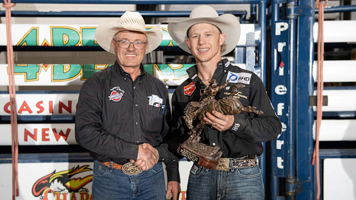 Dawson Hay was all smiles shaking hands with legendary saddle bronc rider Brad Gjermundson after winning the Extreme Broncs event in New Town, N.D., over the weekend to claim more than $36,000 in earnings. 