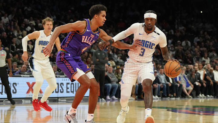 Orlando Magic guard Kentavious Caldwell-Pope (3) drives on Phoenix Suns center Oso Ighodaro (4) during the second half of an NBA game at Footprint Center.