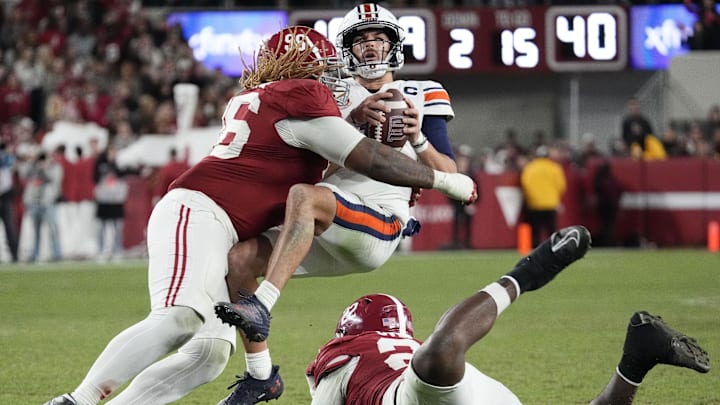 Nov 30, 2024; Tuscaloosa, Alabama, USA;  Alabama Crimson Tide defensive lineman Tim Keenan III (96) hits Auburn Tigers quarterback Payton Thorne (1)  for a loss during the second half at Bryant-Denny Stadium. Alabama won 28-14. Mandatory Credit: Gary Cosby Jr.-Imagn Images