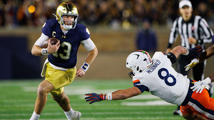 Notre Dame quarterback Riley Leonard (13) runs the ball down the field during a NCAA college football game against Virginia at Notre Dame Stadium on Saturday, Nov. 16, 2024, in South Bend.