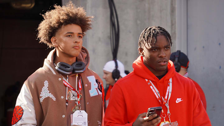 Recruits Dia Bell and Byron Louis watch Ohio State warm up before playing Penn State at Ohio Stadium.