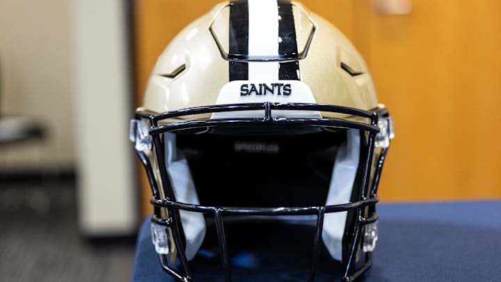 Mar 11, 2023; Metairie, LA, USA; Detailed view of New Orleans Saints helmet at Ochsner Sports Performance Center. Mandatory Credit: Stephen Lew-Imagn Images Mar 11, 2023; Metairie, LA, USA; Detailed view of New Orleans Saints helmet at Ochsner Sports Performance Center. Mandatory Credit: Stephen Lew-Imagn Images