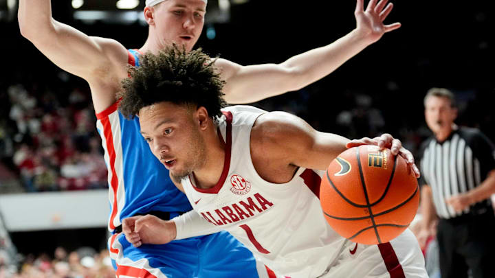 Jan 14, 2025; Tuscaloosa, AL, USA; Alabama guard Mark Sears (1) drives along the baseline with Ole Miss guard Sean Pedulla (3) defending at Coleman Coliseum. Mandatory Credit: Gary Cosby Jr.-Tuscaloosa News