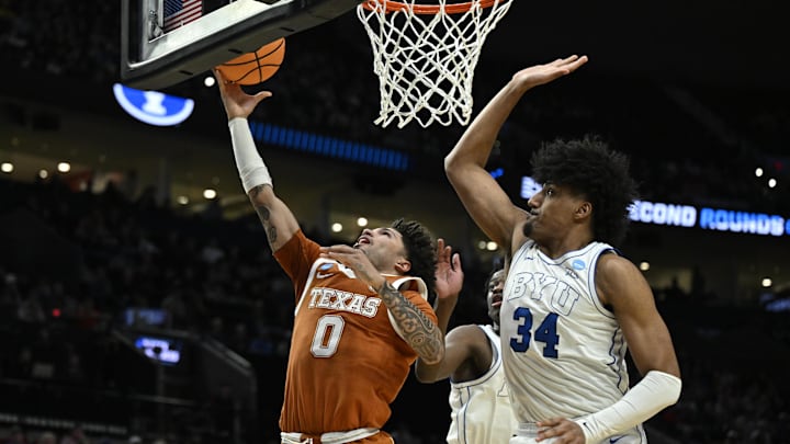 Mar 19, 2026; Portland, OR, USA; Texas Longhorns guard Jordan Pope (0) shoots against BYU Cougars center Abdullah Ahmed (34) in the first half during a first round game of the men's 2026 NCAA Tournament at Moda Center. Mandatory Credit: Troy Wayrynen-Imagn Images