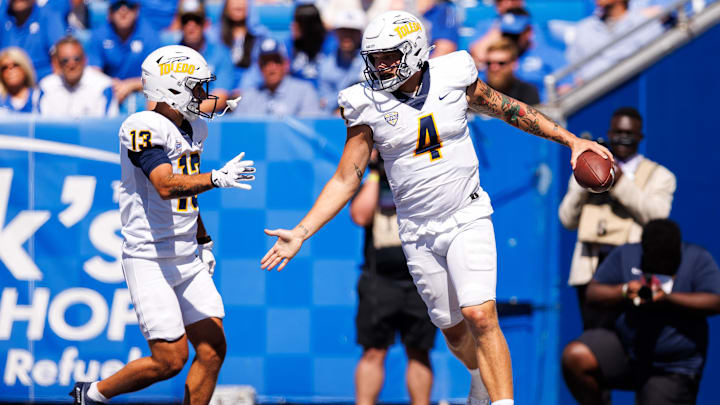 Aug 30, 2025; Lexington, Kentucky, USA; Toledo Rockets quarterback Tucker Gleason (4) celebrates with wide receiver Cooper Rusk (13) after scoring a touchdown during the fourth quarter against the Kentucky Wildcats at Kroger Field. Mandatory Credit: Jordan Prather-Imagn Images