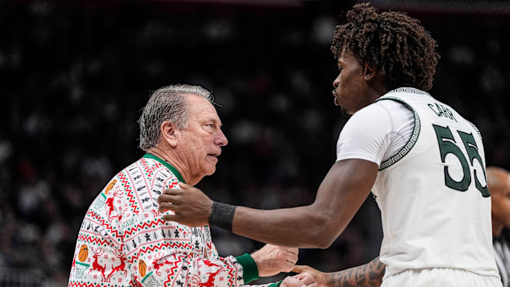Michigan State head coach Tom Izzo talks to forward Coen Carr (55) after a play against Oakland during the second half at Little Caesars Arena in Detroit on Saturday, Dec. 20, 2025.
