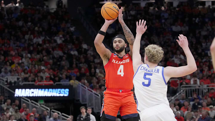 Illinois guard Kylan Boswell (4) hits a three-point basket over Kentucky guard Collin Chandler (5) during the second half of their second round NCAA men’ s basketball tournament game Sunday, March 23, 2025 at Fiserv Forum in Milwaukee, Wisconsin. Kentucky beat Illinois 84-75.