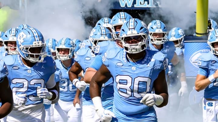 North Carolina running out on the field through smoke before its game against Clemson on Oct. 4, 2025.