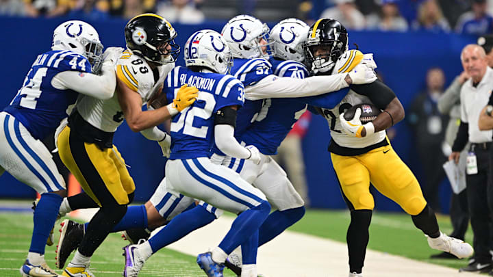Sep 29, 2024; Indianapolis, Indiana, USA; Pittsburgh Steelers running back Najee Harris (22) is pushed out of bounds by multiple Indianapolis Colts during the second quarter at Lucas Oil Stadium. Mandatory Credit: Marc Lebryk-Imagn Images