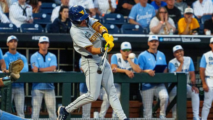 Jun 14, 2026; Omaha, NE, USA; West Virginia Mountaineers second baseman Brodie Kresser (12) hits a single against the North Carolina Tar Heels during the ninth inning at Charles Schwab Field. Mandatory Credit: Dylan Widger-Imagn Images Jun 14, 2026; Omaha, NE, USA; West Virginia Mountaineers second baseman Brodie Kresser (12) hits a single against the North Carolina Tar Heels during the ninth inning at Charles Schwab Field. Mandatory Credit: Dylan Widger-Imagn Images