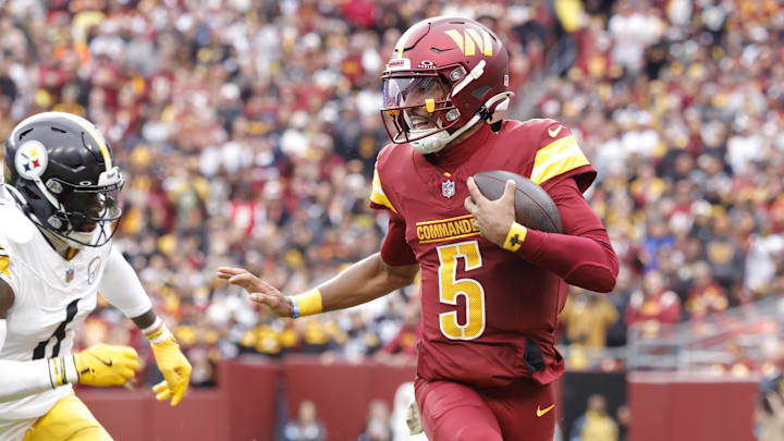 Nov 10, 2024; Landover, Maryland, USA; Washington Commanders quarterback Jayden Daniels (5) carries the ball as Pittsburgh Steelers linebacker Patrick Queen (6) defends during the first half at Northwest Stadium. Mandatory Credit: Amber Searls-Imagn Images