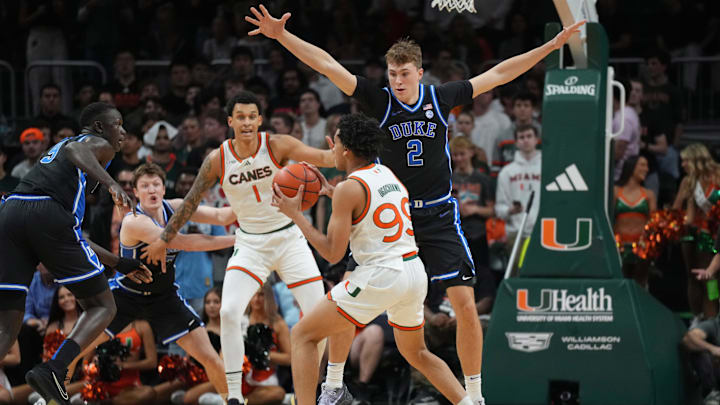 Feb 25, 2025; Coral Gables, Florida, USA;  Duke Blue Devils guard Cooper Flagg (2) defends Miami (Fl) Hurricanes guard Divine Ugochukwu (99) during the first half at Watsco Center. Mandatory Credit: Jim Rassol-Imagn Images