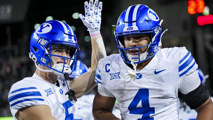 Nov 22, 2025; Cincinnati, Ohio, USA; BYU Cougars running back LJ Martin (4) celebrates with teammates after scoring a touchdown against the Cincinnati Bearcats in the second half at Nippert Stadium. Mandatory Credit: Aaron Doster-Imagn Images