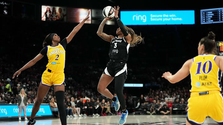 Jun 11, 2025; Las Vegas, Nevada, USA; Las Vegas Aces guard Tiffany Mitchell (3) shoots the ball against Los Angeles Sparks forward Rickea Jackson (2) and guard Kelsey Plum (10) during the first half of a WNBA basketball game at Michelob Ultra Arena. Mandatory Credit: Lucas Peltier-Imagn Images
