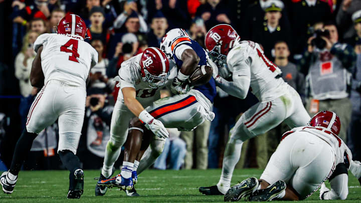 Bray Hubbard (18) forcing a fumble against Auburn.