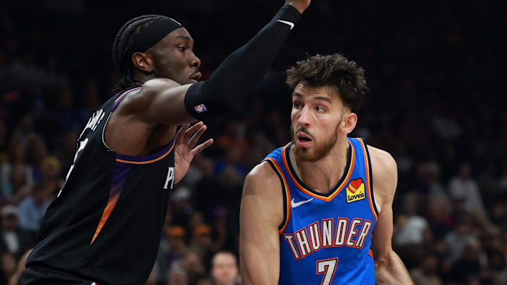 Jan 4, 2026; Phoenix, Arizona, USA; Oklahoma City Thunder center Chet Holmgren (7) against Phoenix Suns center Mark Williams at Mortgage Matchup Center. Mandatory Credit: Mark J. Rebilas-Imagn Images