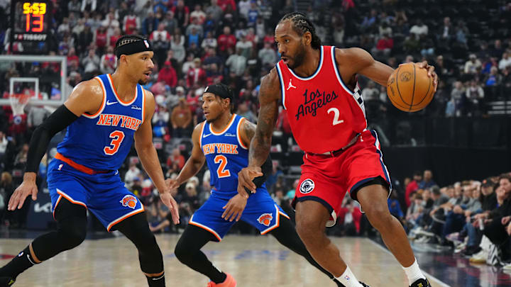 Mar 7, 2025; Inglewood, California, USA; LA Clippers forward Kawhi Leonard (2) dribbles the ball against New York Knicks guard Miles McBride (2) and guard Josh Hart (3) in the first half at Intuit Dome. Mandatory Credit: Kirby Lee-Imagn Images