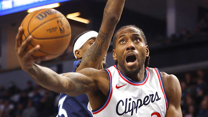 Jan 6, 2025; Minneapolis, Minnesota, USA; Los Angeles Clippers forward Kawhi Leonard (2) goes to the basket against Minnesota Timberwolves forward Jaden McDaniels (3) in the third quarter at Target Center. Mandatory Credit: Bruce Kluckhohn-Imagn Images