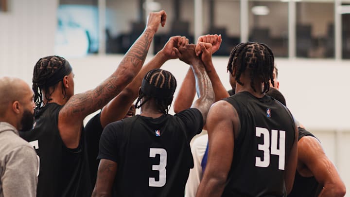 Orlando Magic forward Paolo Banchero, guard Kentavious Caldwell-Pope and center Wendell Carter Jr. huddle during the Magic's second training camp practice.