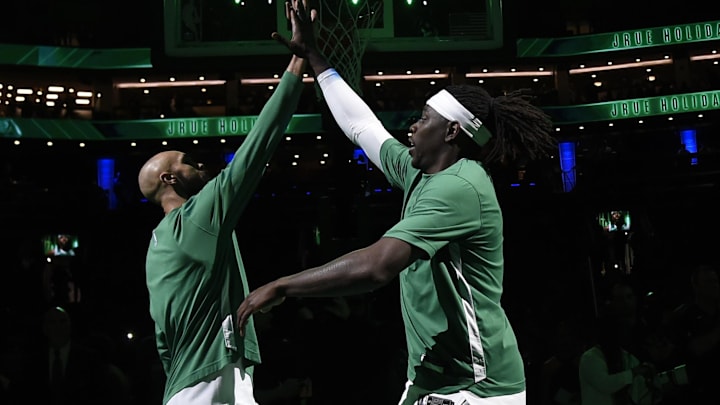 Apr 3, 2024; Boston, Massachusetts, USA; Boston Celtics guard Derrick White (9) high fives guard Jrue Holiday (4) before a game against the Oklahoma City Thunder at TD Garden. Mandatory Credit: Bob DeChiara-Imagn Images