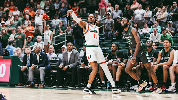 AJ Staton-Mccray shooting and making a three point shot against Binghamton