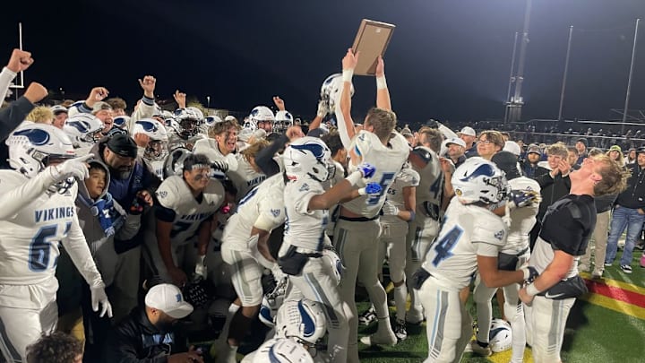 Pleasant Valley holds up the trophy after helping the Vikings win the Northern Section