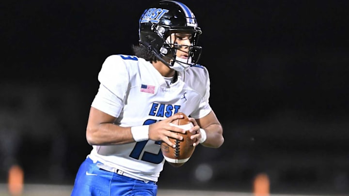 Oregon commit Jonas Williams (13) tossed three touchdowns, including the 100th of his high school career, in leading top-ranked Lincoln-Way East to a 42-0 win over Niles West in the opening round of the Class 8A state playoffs.