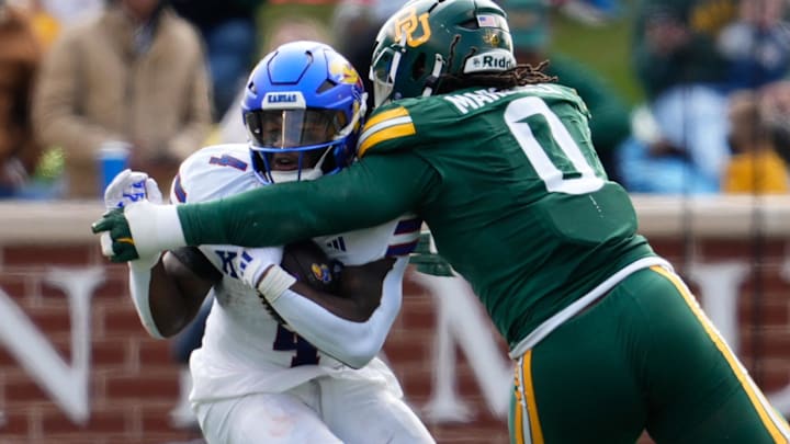 Nov 30, 2024; Waco, Texas, USA; Kansas Jayhawks running back Devin Neal (4) is stopped after a short gain by Baylor Bears defensive lineman Jackie Marshall (0) during the first half at McLane Stadium. Mandatory Credit: Chris Jones-Imagn Images Nov 30, 2024; Waco, Texas, USA; Kansas Jayhawks running back Devin Neal (4) is stopped after a short gain by Baylor Bears defensive lineman Jackie Marshall (0) during the first half at McLane Stadium. Mandatory Credit: Chris Jones-Imagn Images