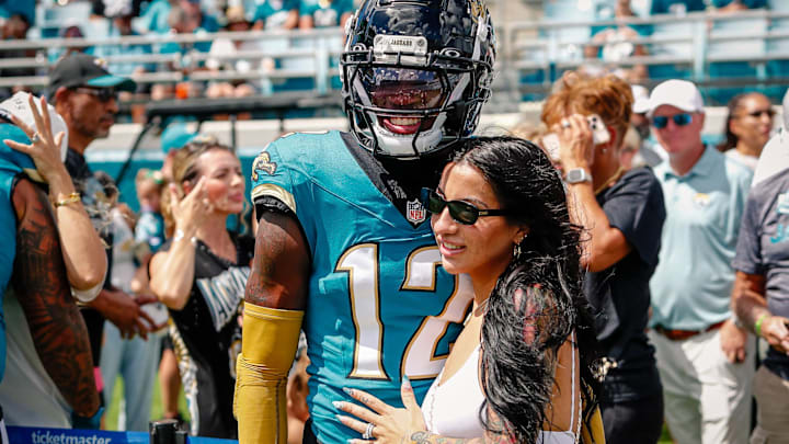 Jacksonville Jaguars player Travis Hunter (12) with his wife during pregame against the Houston Texans at EverBank Stadium.