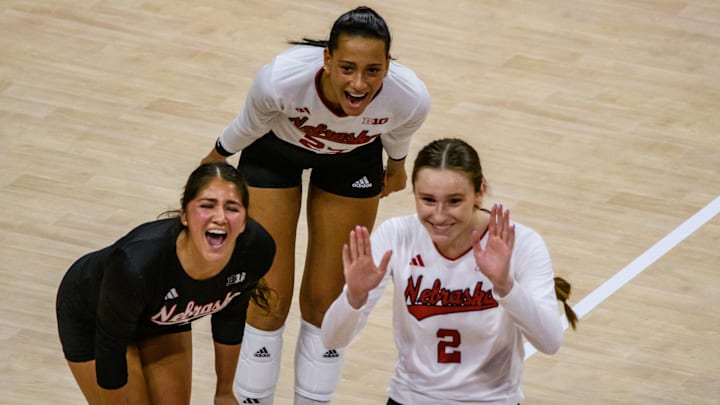 Lexi Rodriguez (left), Harper Murray (middle) and Bergen Reilly celebrate a kill from Rebekah Allick.  