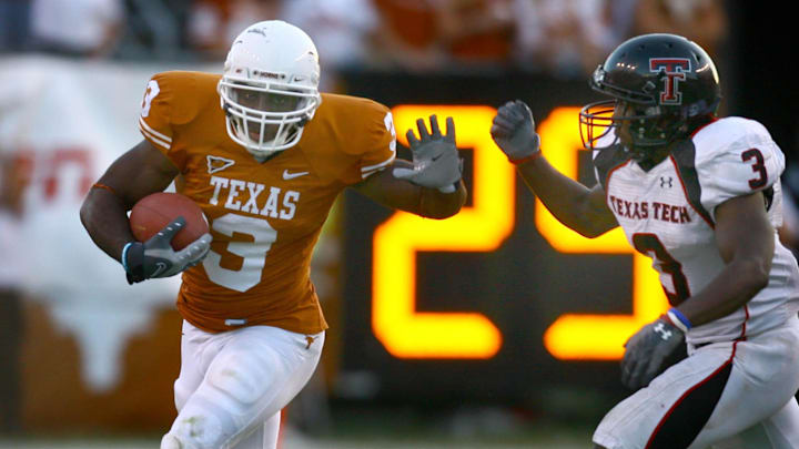 Nov 10, 2007; Austin, TX, USA; Texas Longhorns runningback Chris Ogbonnaya (3) is pursued by Texas Tech Red Raiders defensive back Jamar Wall (3) in the third quarter at Darrell K Royal-Texas Memorial Stadium in Austin, Texas. Texas beat Texas Tech 59-43. Mandatory Credit: Brendan Maloney-Imagn Images