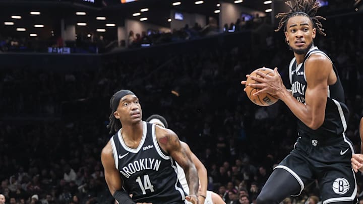 Oct 24, 2025; Brooklyn, New York, USA; Brooklyn Nets center Nic Claxton (33) jumps in between guard Terance Mann (14) and Cleveland Cavaliers guard Jaylon Tyson (20) to grab a rebound in the third quarter at Barclays Center. Mandatory Credit: Wendell Cruz-Imagn Images Oct 24, 2025; Brooklyn, New York, USA; Brooklyn Nets center Nic Claxton (33) jumps in between guard Terance Mann (14) and Cleveland Cavaliers guard Jaylon Tyson (20) to grab a rebound in the third quarter at Barclays Center. Mandatory Credit: Wendell Cruz-Imagn Images