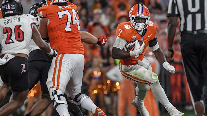 Nov 2, 2024; Clemson, South Carolina, USA; Clemson Tigers running back Phil Mafah (7) runs against Louisville Cardinals defensive back MJ Griffin (26) during the second quarter at Memorial Stadium. 