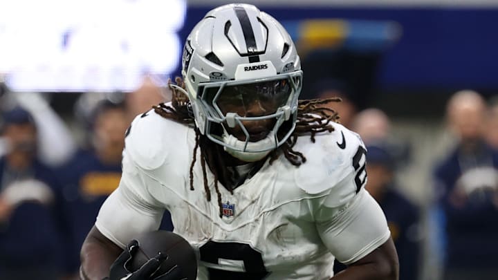 Nov 30, 2025; Inglewood, California, USA; Las Vegas Raiders running back Ashton Jeanty (2) rushes the ball against the Los Angeles Chargers during the second half at SoFi Stadium. Mandatory Credit: Kiyoshi Mio-Imagn Images