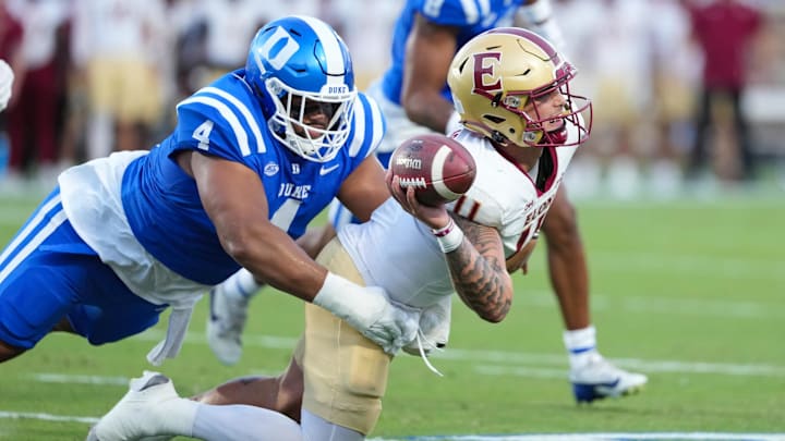 Aug 28, 2025; Durham, North Carolina, USA;  Duke Blue Devils defensive tackle Josiah Green (4) sacks Elon Phoenix quarterback Landen Clark (11) during the first half at Wallace Wade Stadium. Mandatory Credit: James Guillory-Imagn Images