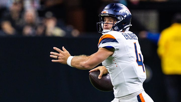 Aug 23, 2025; New Orleans, Louisiana, USA; Denver Broncos quarterback Sam Ehlinger (4) scrambles out of the pocket against New Orleans Saints safety Ugo Amadi (0) during the first half at Caesars Superdome. Mandatory Credit: Stephen Lew-Imagn Images Aug 23, 2025; New Orleans, Louisiana, USA; Denver Broncos quarterback Sam Ehlinger (4) scrambles out of the pocket against New Orleans Saints safety Ugo Amadi (0) during the first half at Caesars Superdome. Mandatory Credit: Stephen Lew-Imagn Images