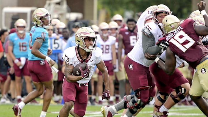 Apr 20, 2024; Tallahassee, Florida, USA; Florida State Seminoles running back Jaylin Lucas (13) runs with the ball during the Spring Showcase at Doak S. Campbell Stadium. Mandatory Credit: Melina Myers-Imagn Images