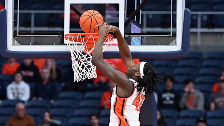 Nov 8, 2025; Syracuse, New York, USA; Syracuse Orange forward William Kyle III (42) dunks the ball over Delaware State Hornets forward Cyril Obasogie (10) in the first half  at the JMA Wireless Dome. Mandatory Credit: Mark Konezny-Imagn Images