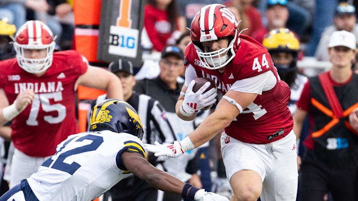 Indiana Hoosiers tight end Zach Horton (44) runs with the ball while Michigan Wolverines defensive back Ricky Johnson (22) defends in the second quarter at Memorial Stadium.