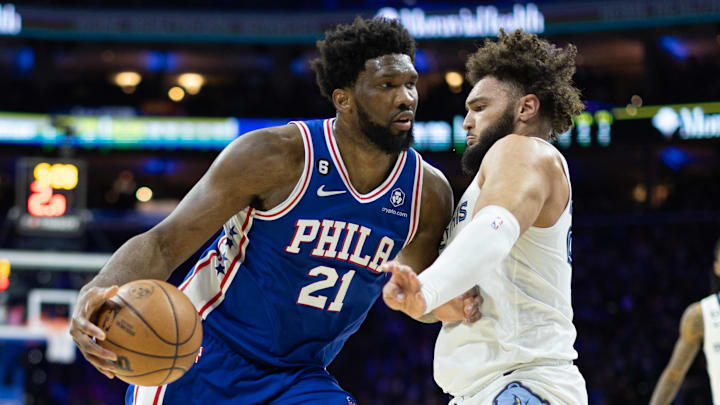 Feb 23, 2023; Philadelphia, Pennsylvania, USA; Philadelphia 76ers center Joel Embiid (21) drives against Memphis Grizzlies forward David Roddy (27) during the second quarter at Wells Fargo Center. Mandatory Credit: Bill Streicher-Imagn Images