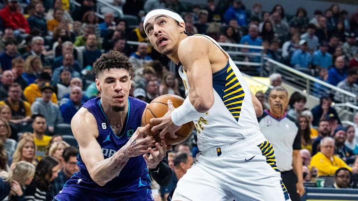 Jan 8, 2023; Indianapolis, Indiana, USA; Indiana Pacers guard Andrew Nembhard (2) dribbles the ball while Charlotte Hornets guard LaMelo Ball (1) defends in the first quarter at Gainbridge Fieldhouse. Mandatory Credit: Trevor Ruszkowski-Imagn Images