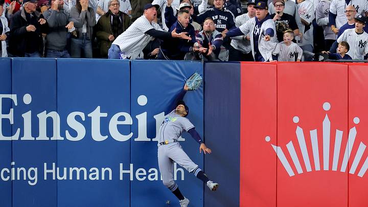 Oct 7, 2026; Bronx, New York, USA; Tampa Bay Rays left fielder Victor Mesa Jr. (25) can't catch a two run home run hit by New York Yankees second baseman Anthony Volpe (not pictured) during the sixth inning of game three of the ALDS during the 2026 MLB Playoffs at Yankee Stadium. After review the umpires changed their call to spectator interference and Volpe was awarded an RBI double. Mandatory Credit: Brad Penner-Imagn Images