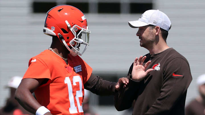 Browns quarterback Shedeur Sanders works with offensive coordinator Tommy Rees during rookie minicamp May 9, 2025, in Berea.